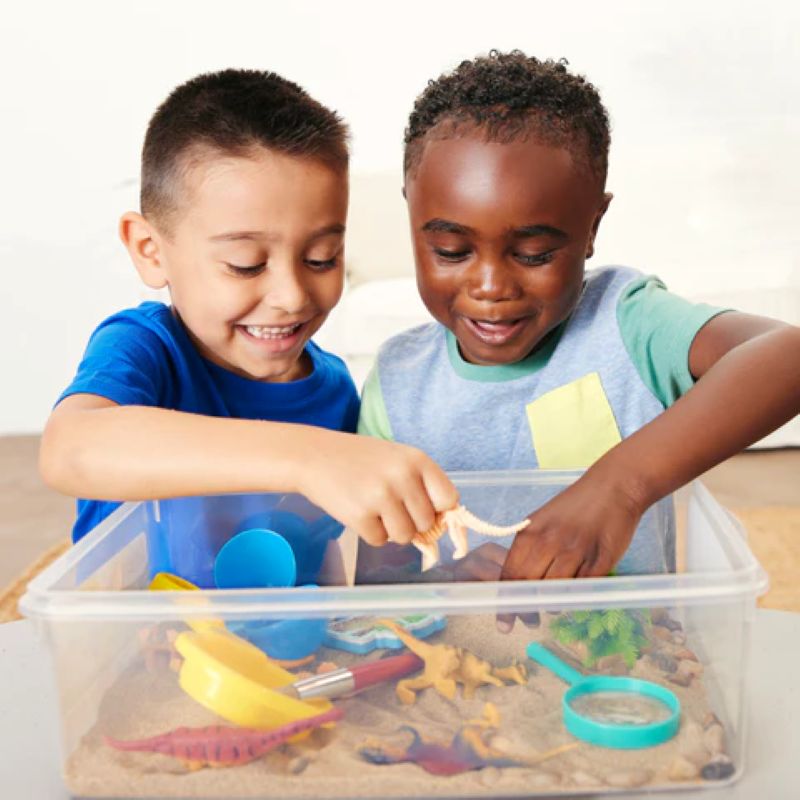 2 boys playing with sensory bins
