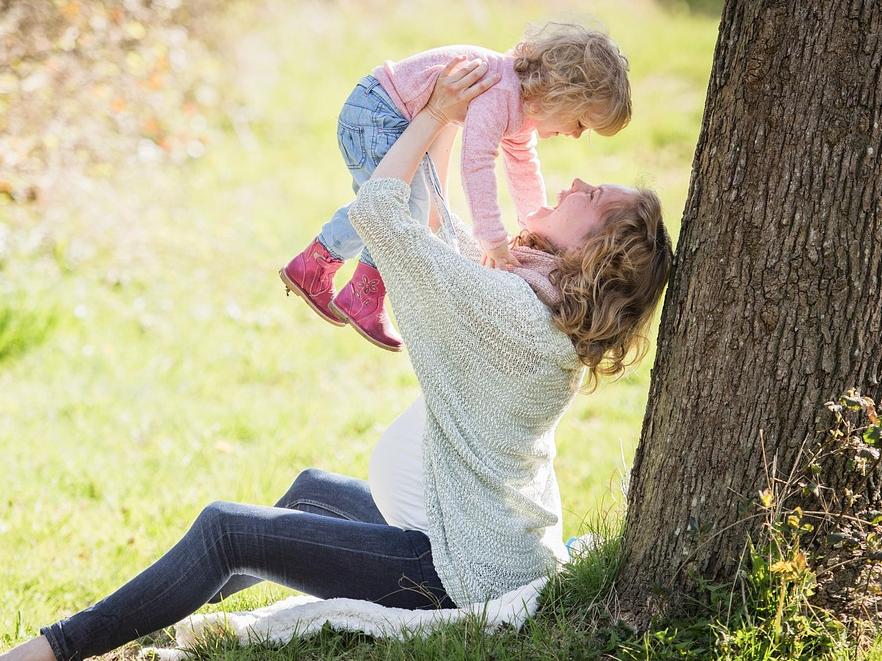 Mom and Baby against a tree